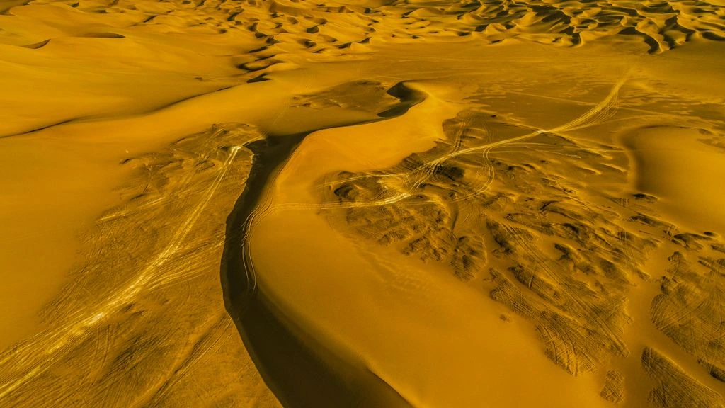 A winding desert road at golden hour, photographed from above for the Destinations hub.
