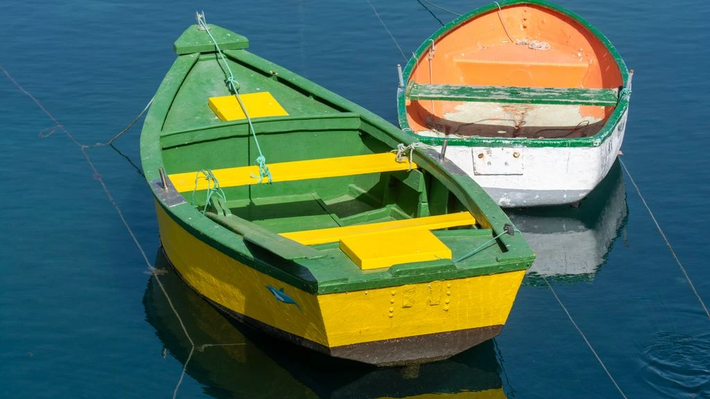 Wooden boat on still water at dawn in Hoi An